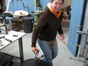 Sharon drills a hole in our practice tire